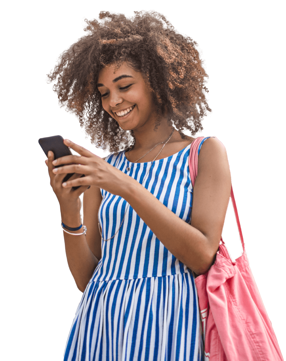 curly haired lady smiling at phone