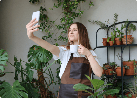 women taking selfie with coffee mug