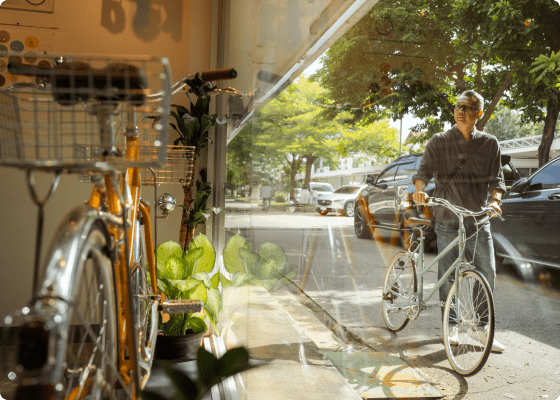 man walking with bicycle on street