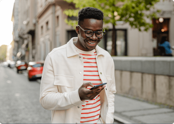 smiling man looking at his phone 