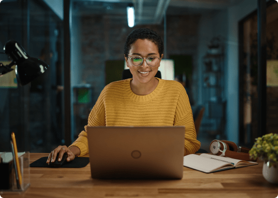 smiley women working on laptop 