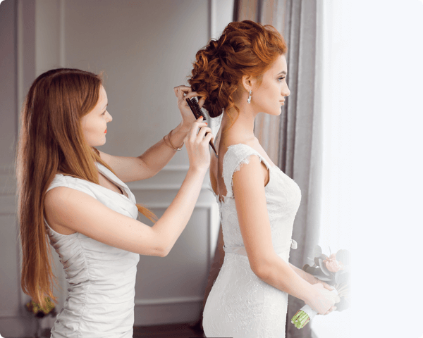 A bride getting her hair done on her wedding day