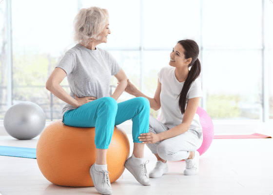 Two women talking in a yoga room