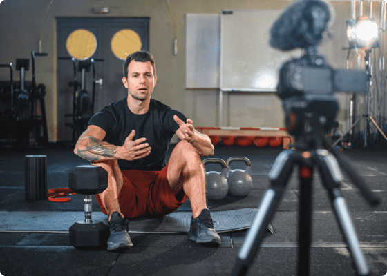 A man sitting on floor with dumbbells