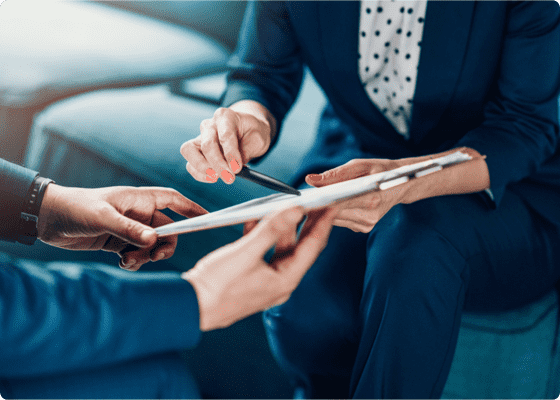 A tablet held by two people to discuss