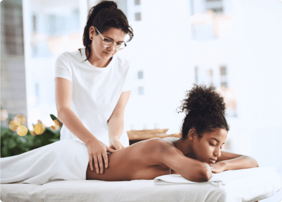 A woman massaging other in a room