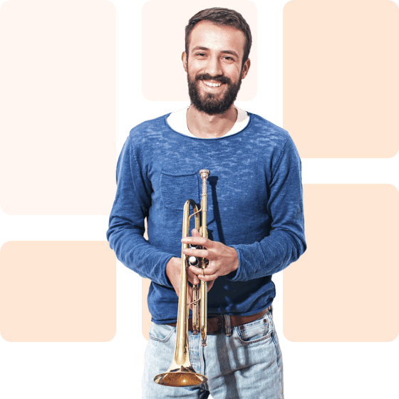 smiling man with trumpet in hand
