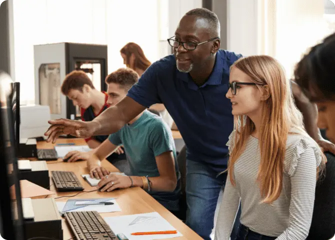 Man explaining something to girl from desktop