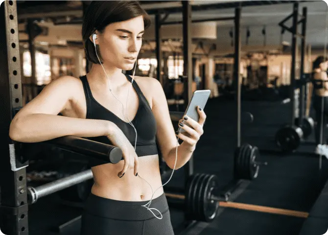 a woman training and checking her phone