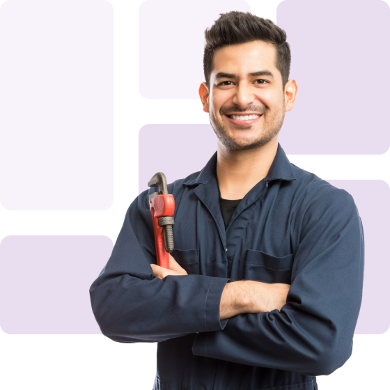 smiling plumber with equipment in hand