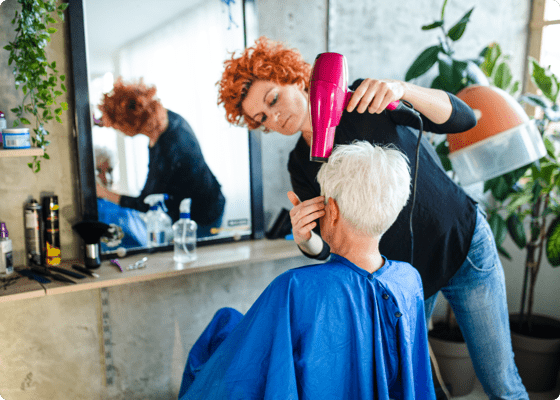 salon stylist giving client a blowdry