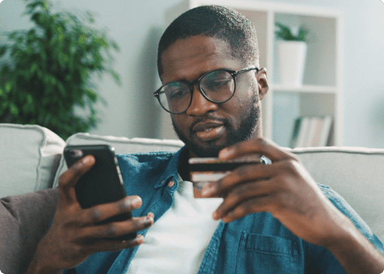 man in blue shirt paying online for appointment