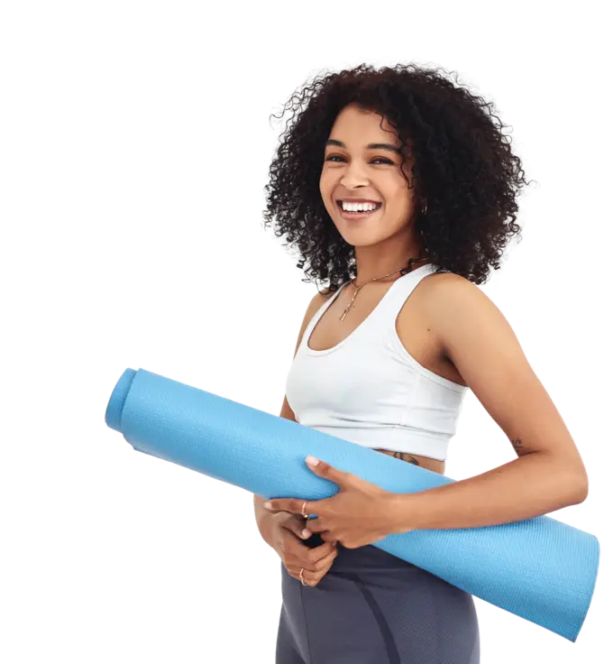 Happy woman standing with yoga mat