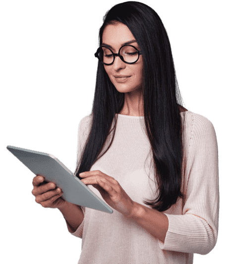 A woman in spectacles holding a tablet in her hand